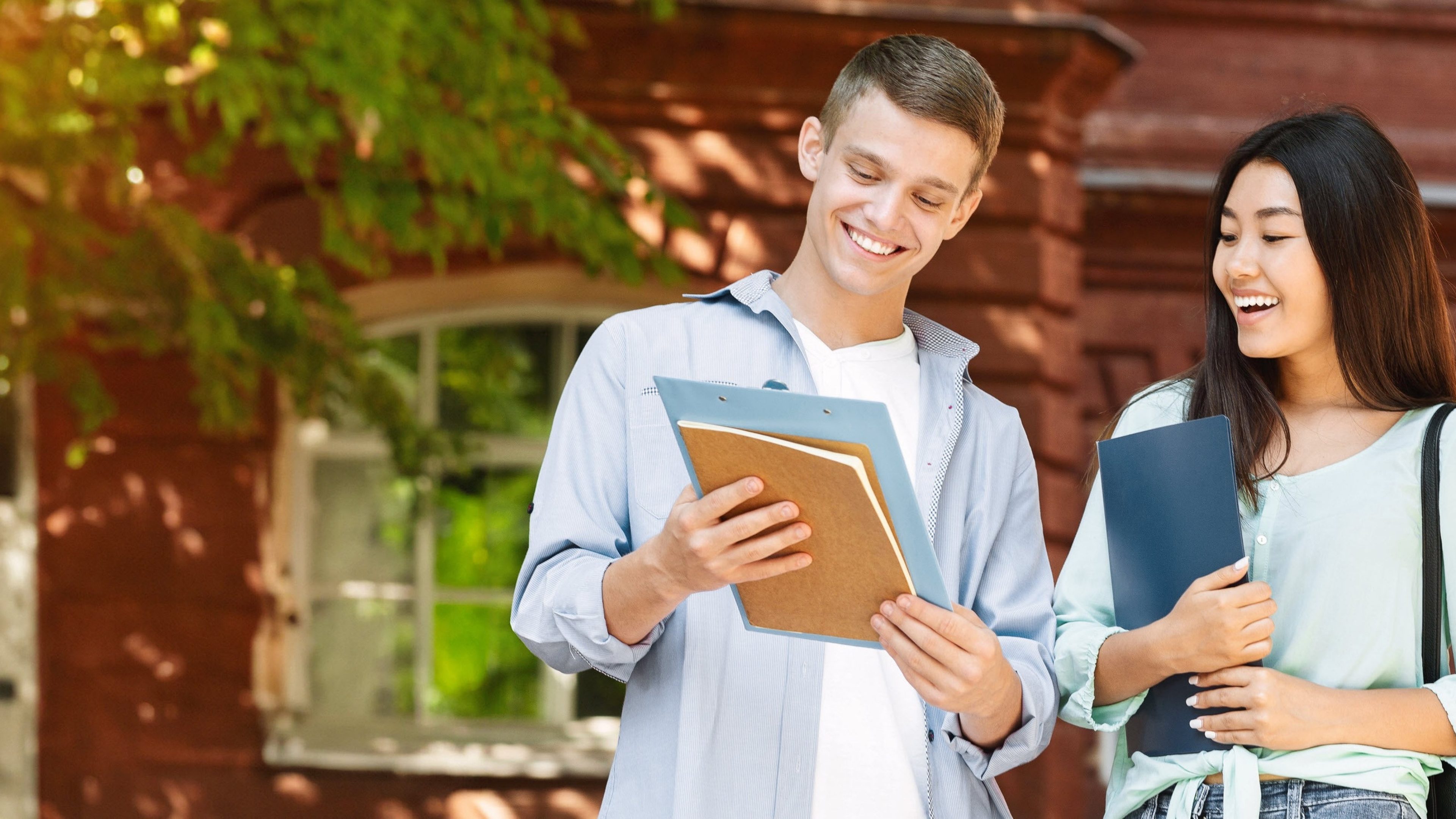 Two students looking at the Swiss Life Asset Managers Study Award.