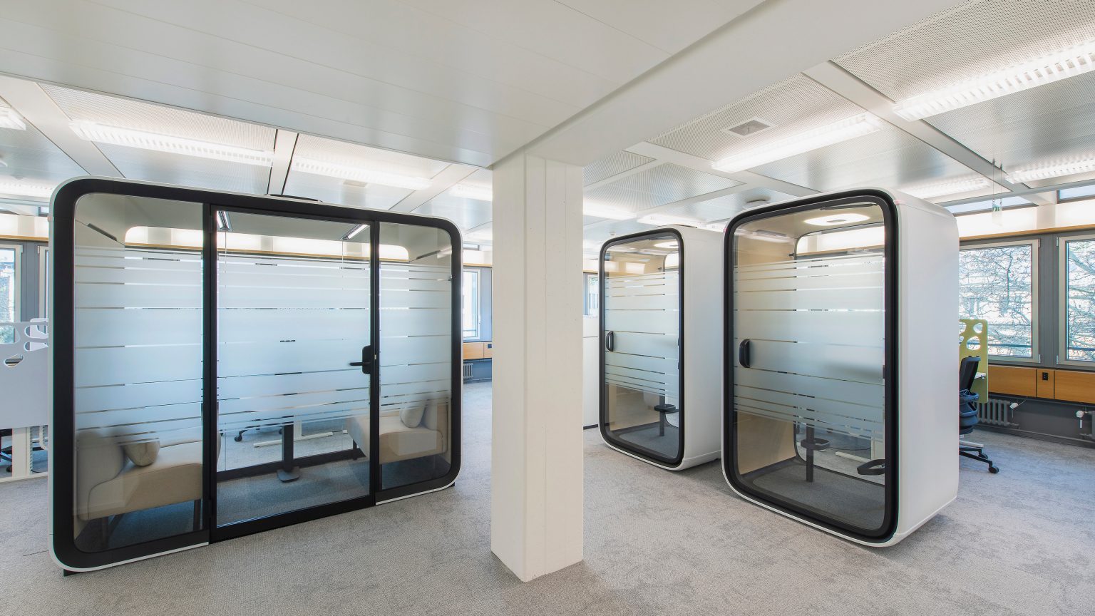 An office with three meeting booths.