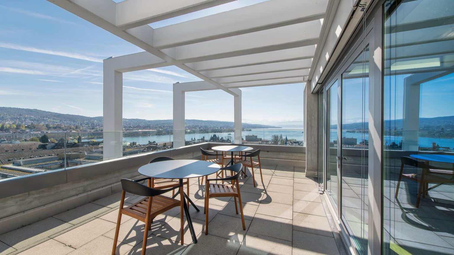 A terrace with chairs and tables.